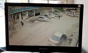 İşyeri çevresindeki yol ve park alanını gösteren güvenlik kamerası görüntüsü